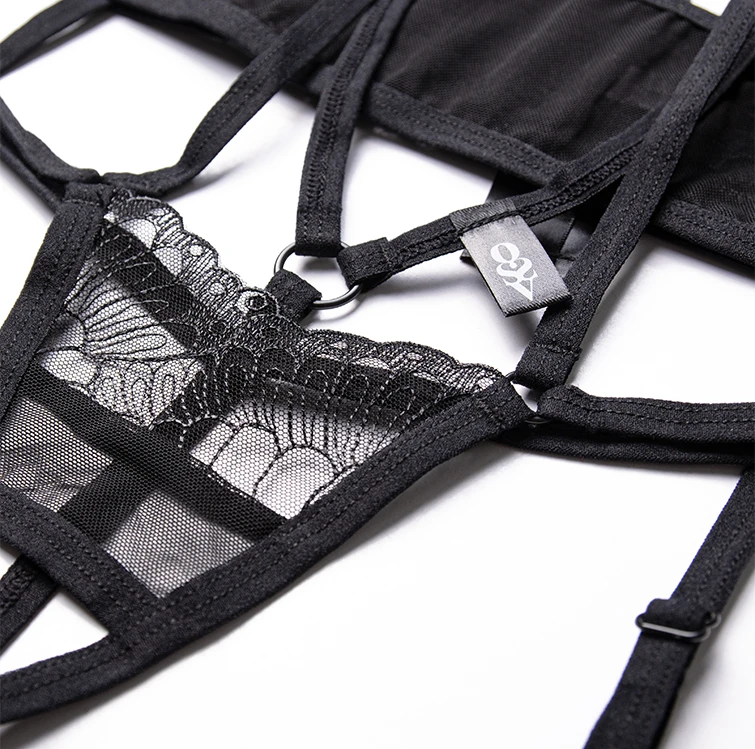 Flat lay photo: black lingerie set on a white table